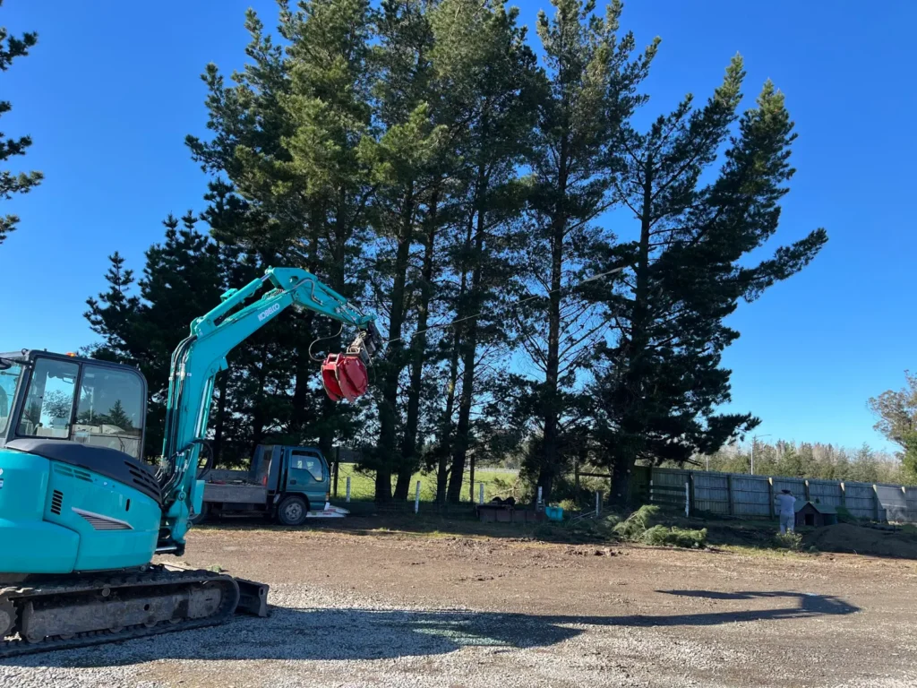 Excavator working on a Canterbury site under blue skies