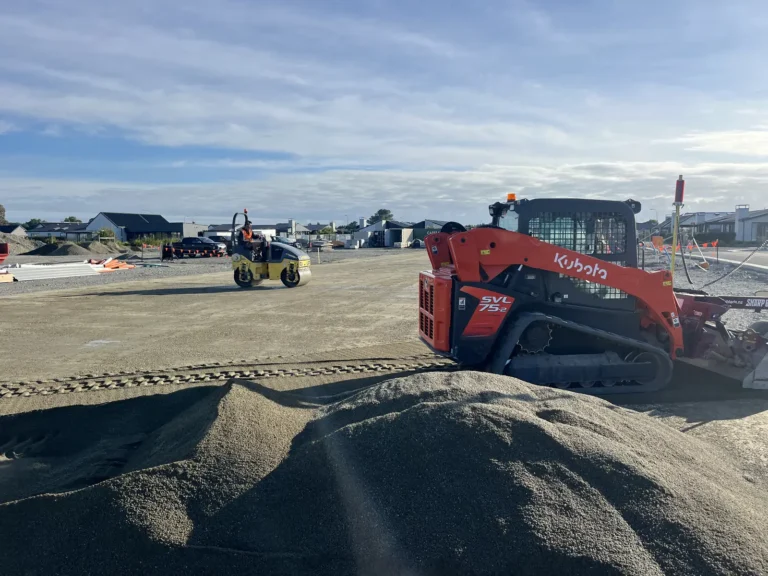 Kubota track loader spreading base course for foundation prep in Christchurch