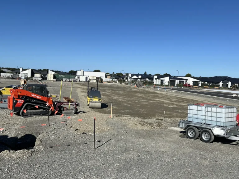 Skid steer and roller preparing a building site in a Christchurch subdivision