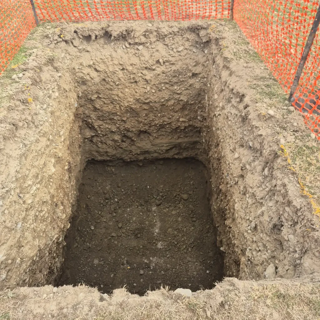 Excavated soak pit with safety fencing for a Canterbury drainage job