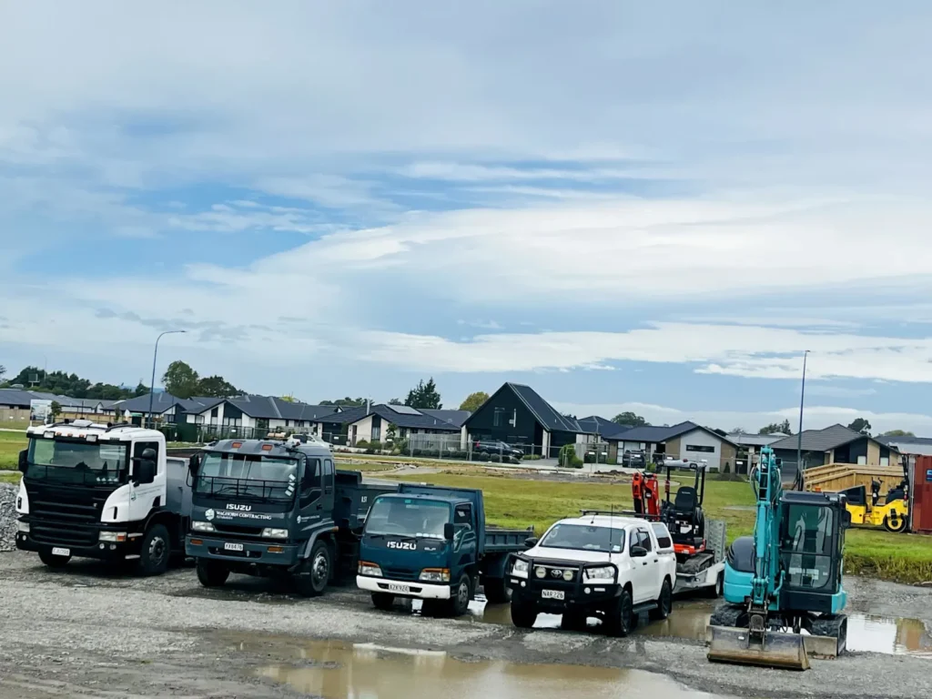 Waghorn Contracting trucks, ute and excavator lined up on site